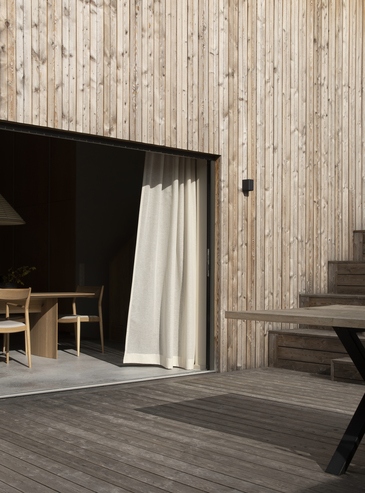 Wood facade with dark window opening and precise exterior edges