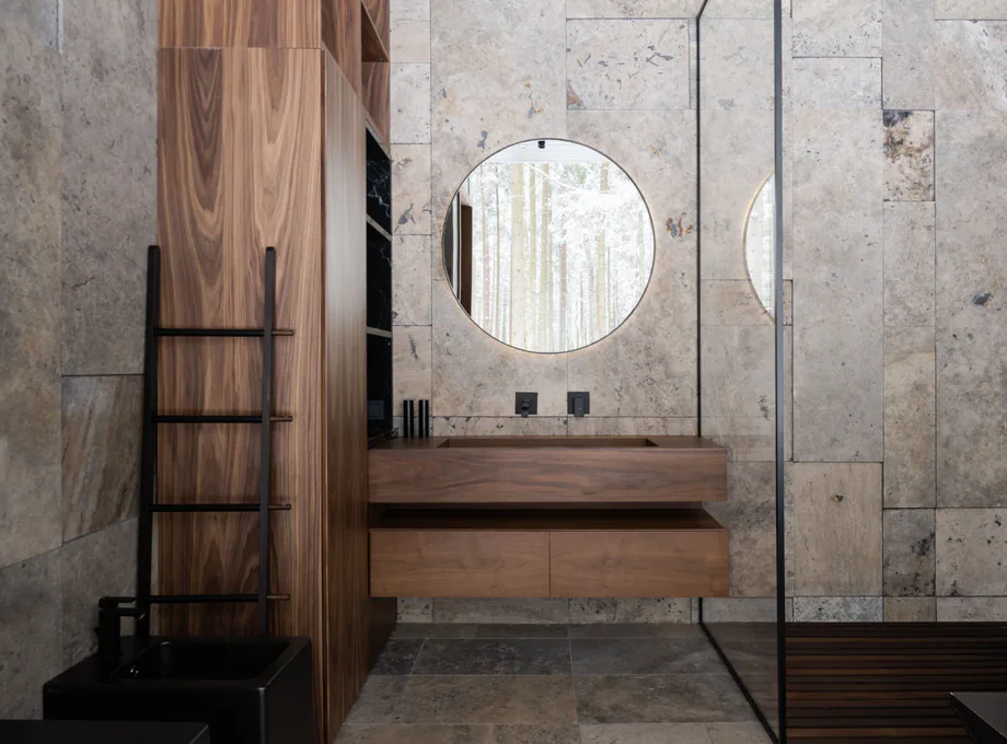 Dark bathroom with natural stone, wood, and black fixtures